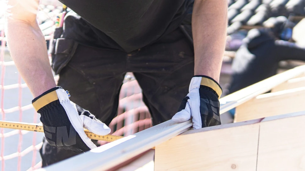 Person arbeitet an einer Holzkonstruktion