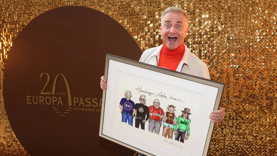 Jörg Knör hält ein Kunstwerk in der Hand